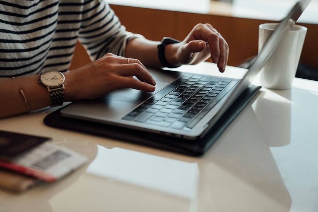 writer typing on laptop